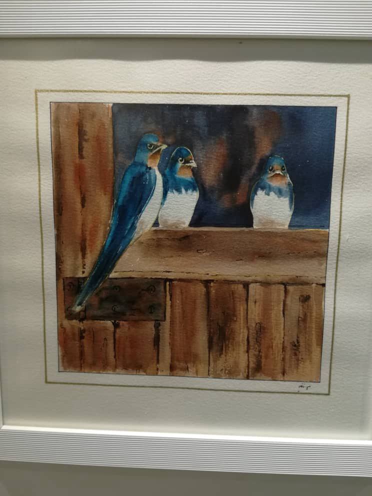Watercolor painting of three blue birds on a wooden ledge